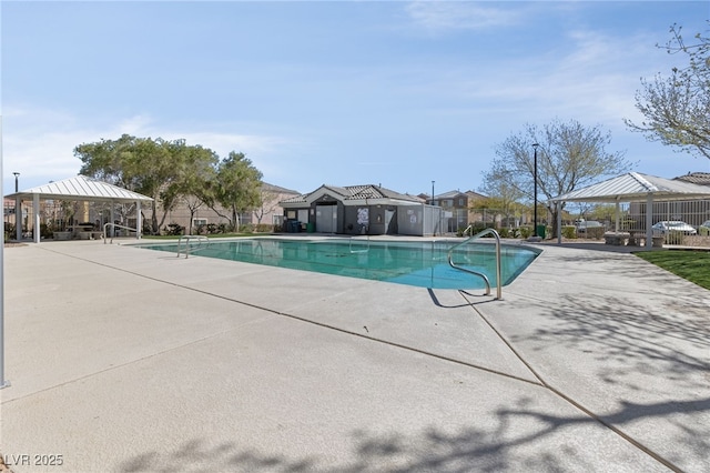 pool with a gazebo, a patio area, and fence