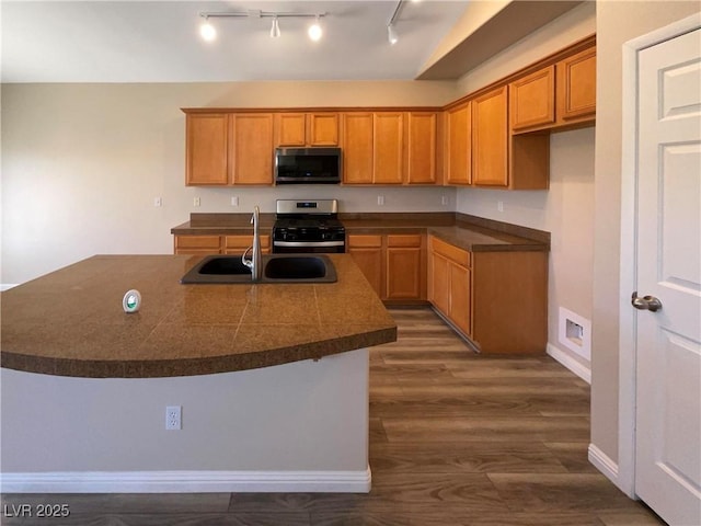 kitchen with stainless steel appliances, dark wood-type flooring, and sink