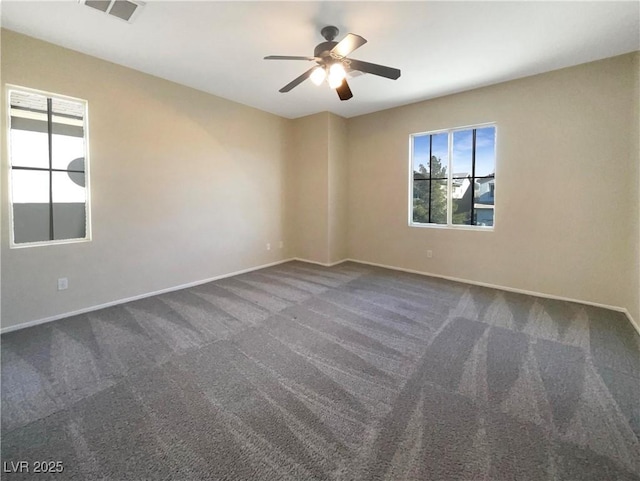 carpeted spare room featuring ceiling fan