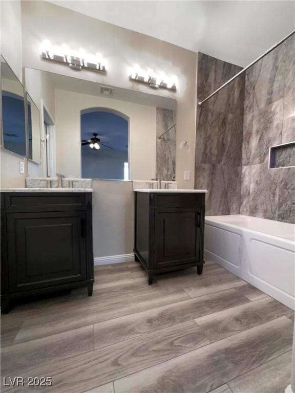 bathroom featuring ceiling fan, shower / tub combination, and vanity