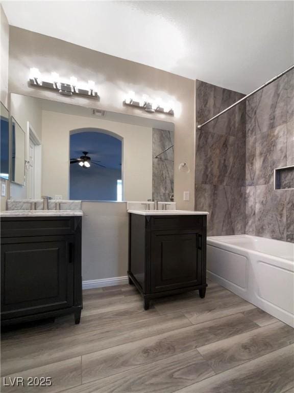 bathroom with vanity, shower / washtub combination, ceiling fan, and hardwood / wood-style flooring