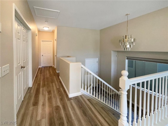 corridor featuring a chandelier and wood-type flooring