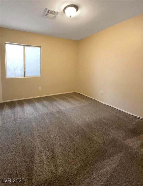 empty room featuring dark carpet