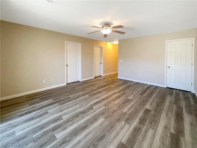 spare room featuring ceiling fan and dark hardwood / wood-style floors