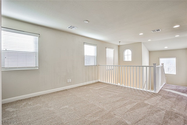 carpeted empty room with a wealth of natural light