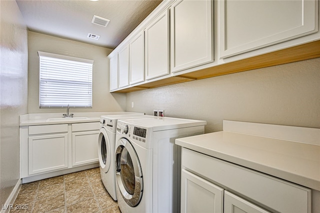 laundry area with sink, cabinets, and washing machine and clothes dryer