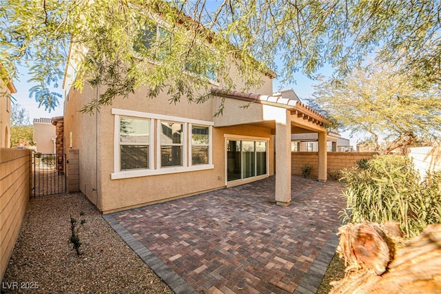 back of property with a patio