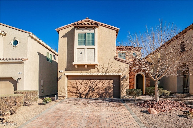 mediterranean / spanish house with a garage