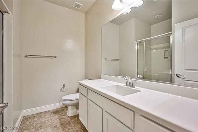 bathroom featuring toilet, a shower with shower door, and vanity