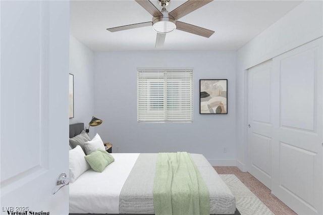 carpeted bedroom with ceiling fan and a closet