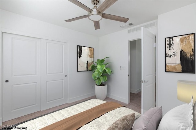 carpeted bedroom with ceiling fan and a closet