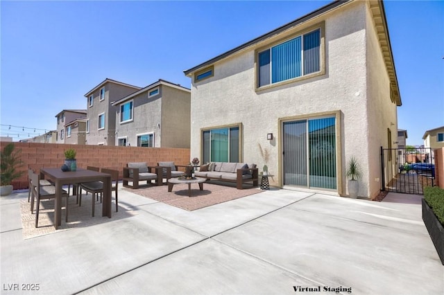 back of property featuring an outdoor living space with a fire pit and a patio