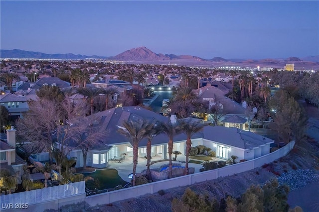 aerial view at dusk featuring a mountain view