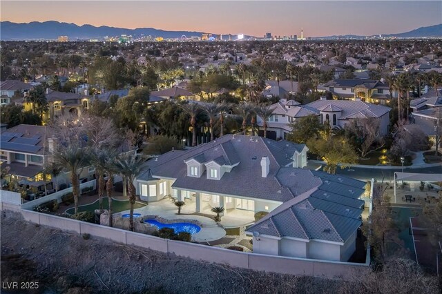 aerial view at dusk featuring a mountain view