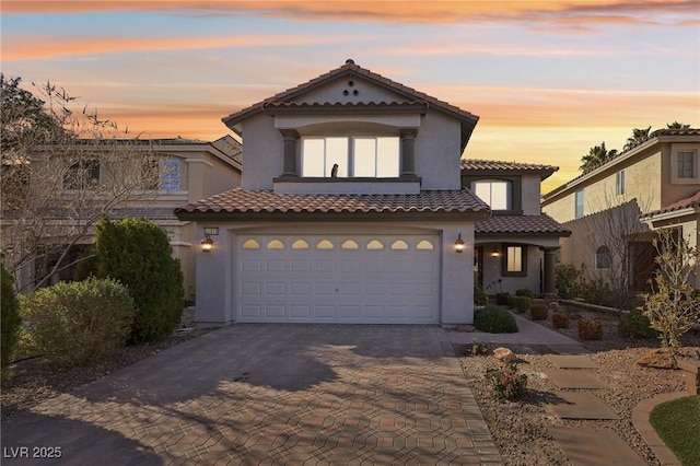 mediterranean / spanish-style house with a garage