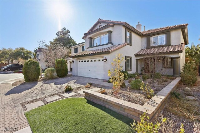 mediterranean / spanish home featuring a garage