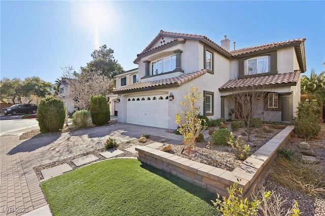 mediterranean / spanish house featuring a garage, concrete driveway, a tiled roof, stucco siding, and a chimney