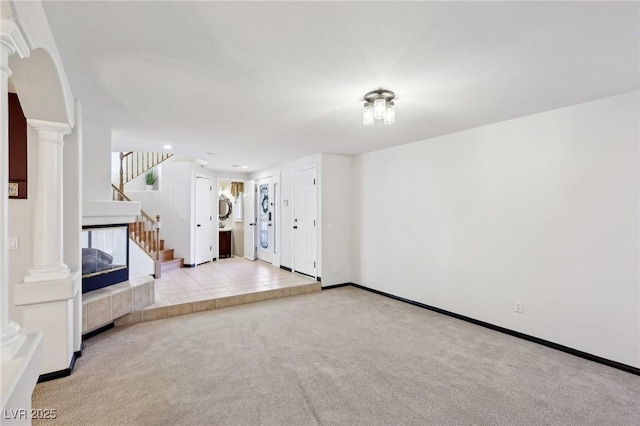 unfurnished living room with a fireplace and light carpet