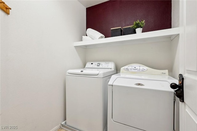 clothes washing area with separate washer and dryer