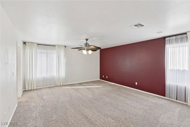 empty room featuring light carpet and ceiling fan