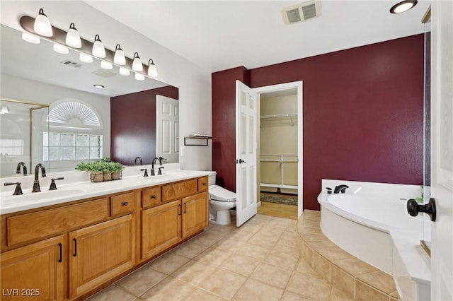 full bathroom with toilet, vanity, tile patterned flooring, and separate shower and tub