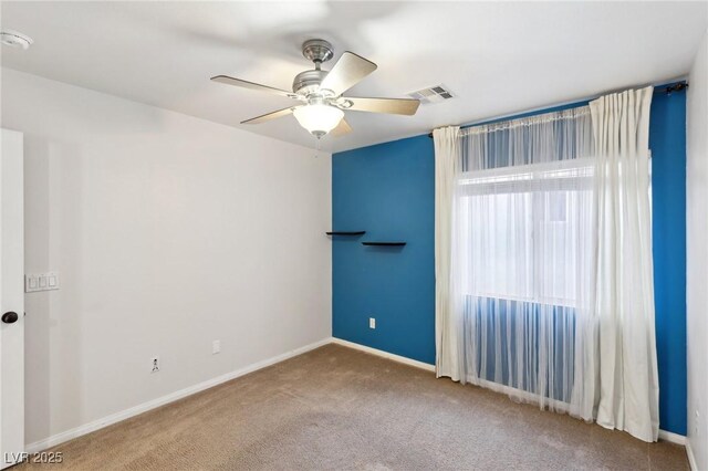 carpeted empty room with ceiling fan