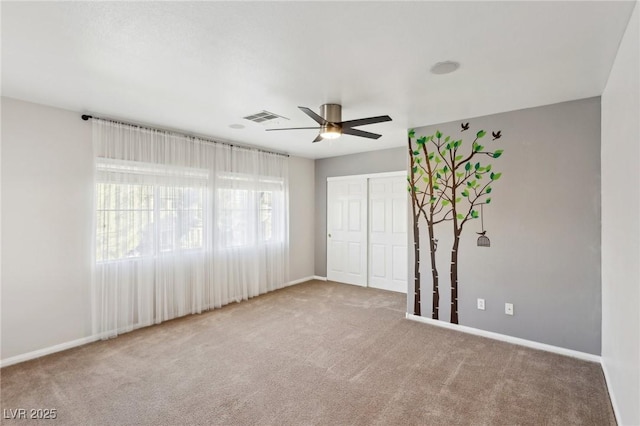 carpeted empty room with ceiling fan