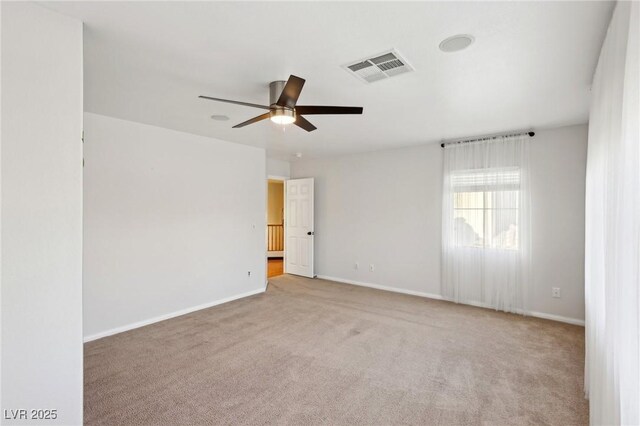 empty room with ceiling fan and light colored carpet