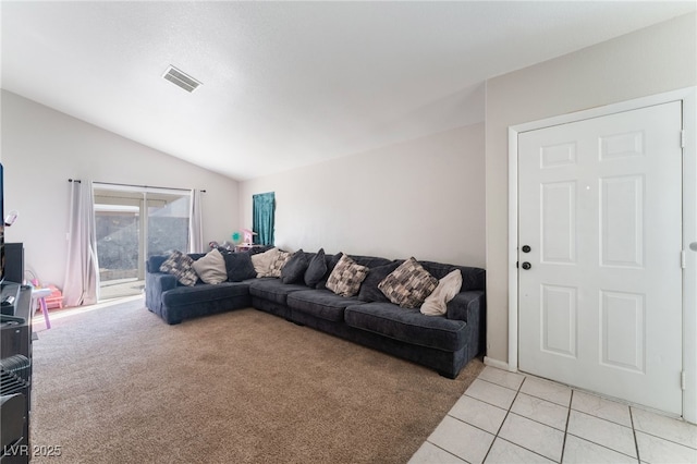 living room featuring lofted ceiling and light tile patterned floors