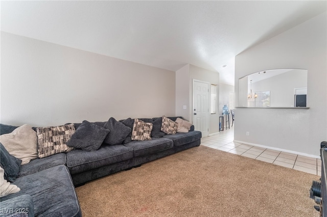 living room featuring vaulted ceiling, light tile patterned floors, and a notable chandelier