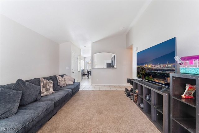 carpeted living room featuring vaulted ceiling