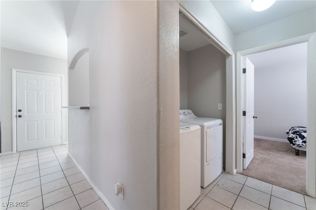 washroom with light tile patterned floors and washer and clothes dryer