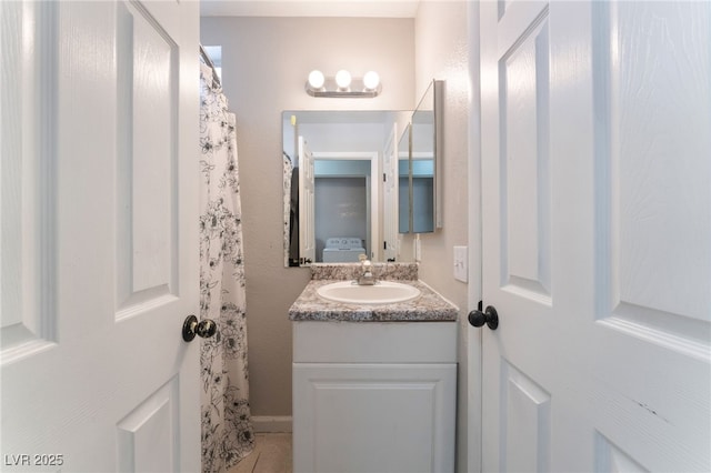 bathroom with tile patterned flooring and vanity