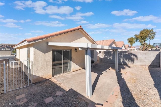 rear view of property featuring a patio area