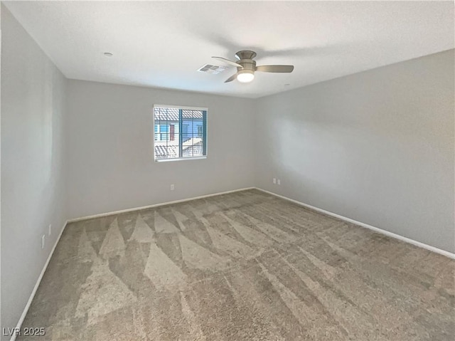 carpeted spare room featuring ceiling fan