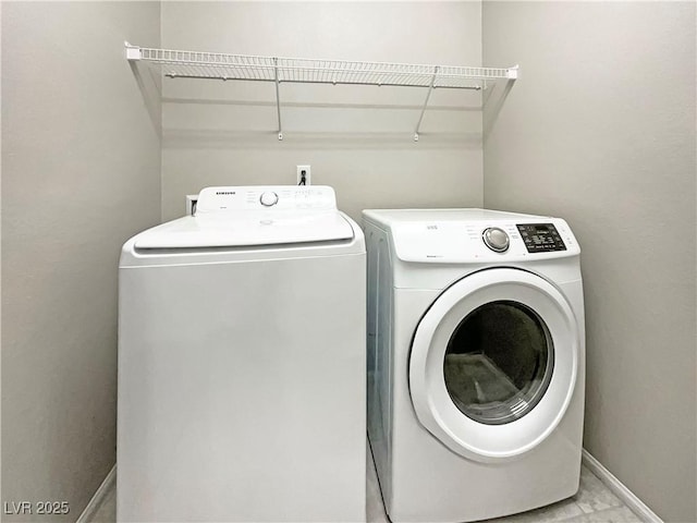 washroom featuring washer and clothes dryer