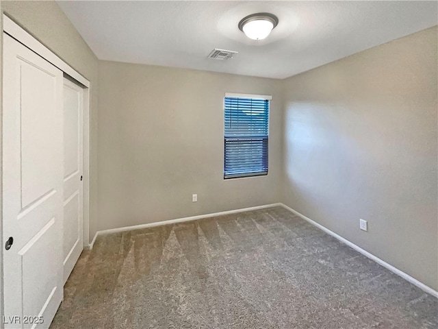 unfurnished bedroom featuring a closet and dark colored carpet