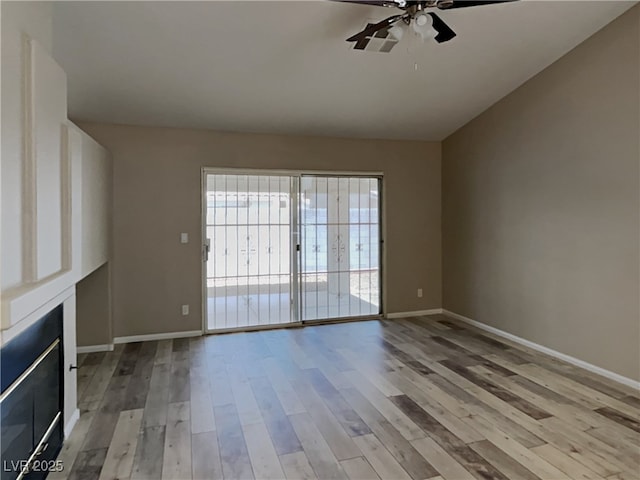 unfurnished living room with light wood-type flooring and ceiling fan