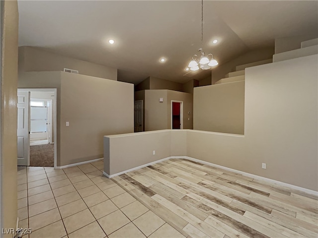 unfurnished room with high vaulted ceiling and a chandelier