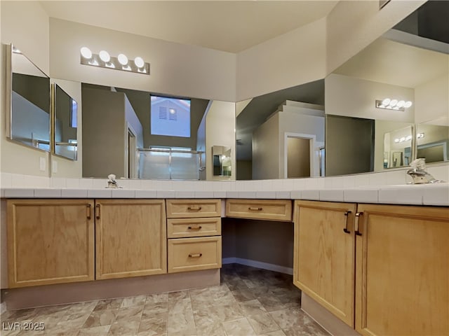 bathroom with walk in shower and vanity