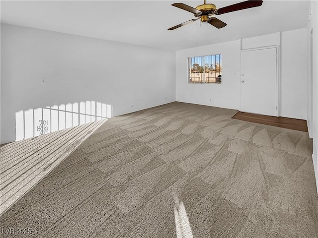 empty room with ceiling fan and carpet flooring