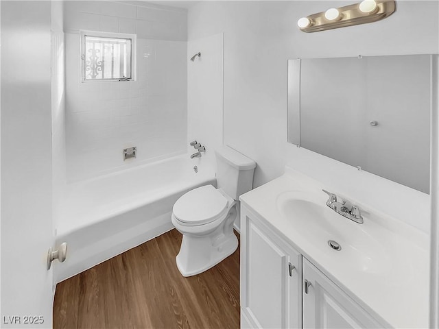 full bathroom with bathtub / shower combination, toilet, vanity, and wood-type flooring