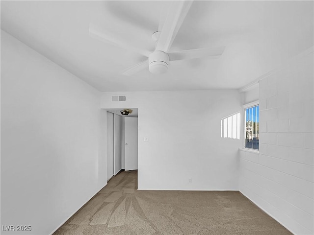 carpeted spare room with ceiling fan