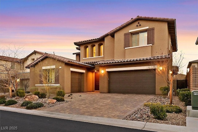 mediterranean / spanish house featuring a garage