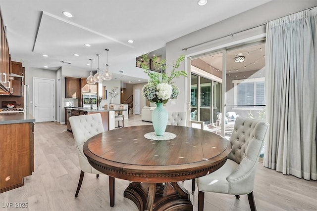 dining area featuring a healthy amount of sunlight and light hardwood / wood-style flooring