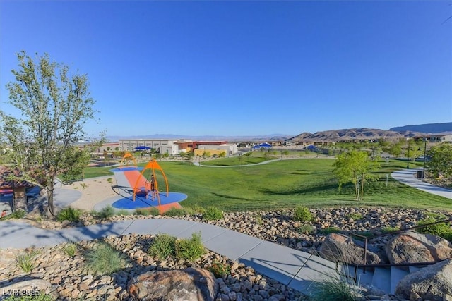 view of property's community with a yard and a mountain view