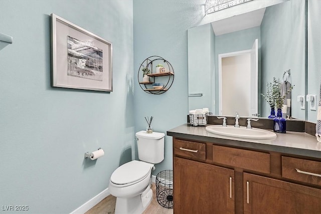 bathroom featuring toilet and vanity