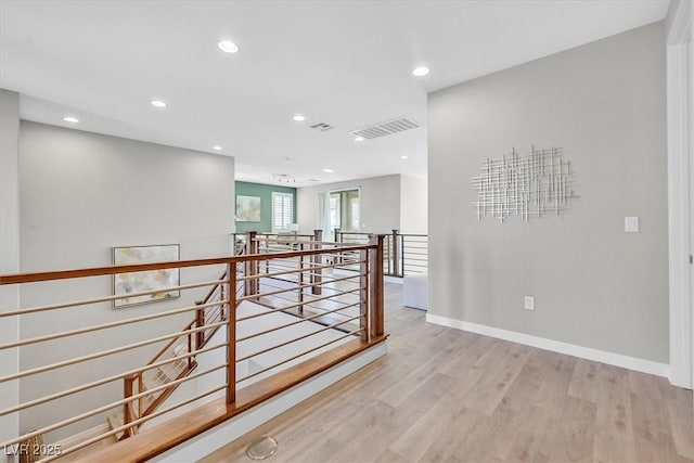 hall with light hardwood / wood-style floors