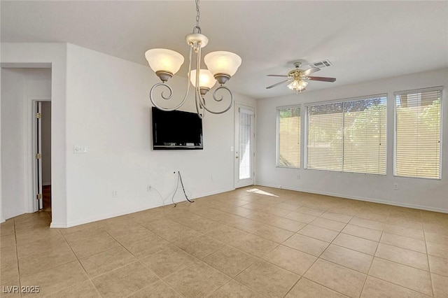 tiled empty room featuring ceiling fan with notable chandelier