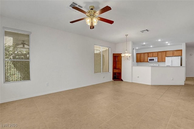 unfurnished living room with ceiling fan with notable chandelier